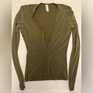 Deep V olive tone fitted long-sleeved shirt.